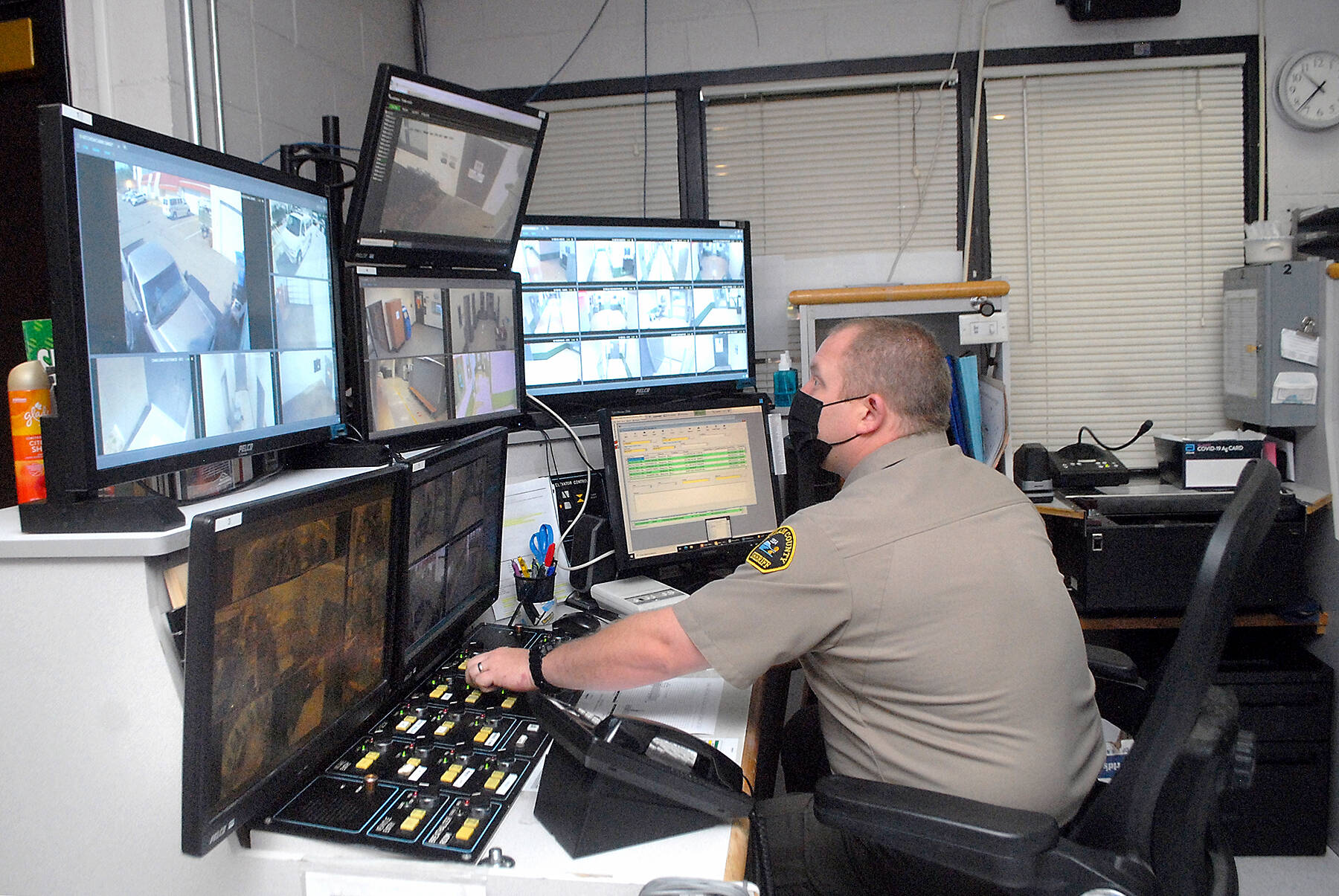 File Photo. Deputy Rick Bray watches surveillance monitors from the control room at the Clallam County Jail on Wednesday in Port Angeles. (Keith Thorpe/Peninsula Daily News)