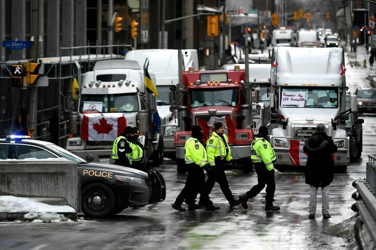Police officers patrol on foot along Albert Street as a protest against COVID-19 restrictions that has been marked by gridlock and the sound of truck horns reaches its 14th day, in Ottawa, Thursday, Feb. 10, 2022. THE CANADIAN PRESS/Justin Tang