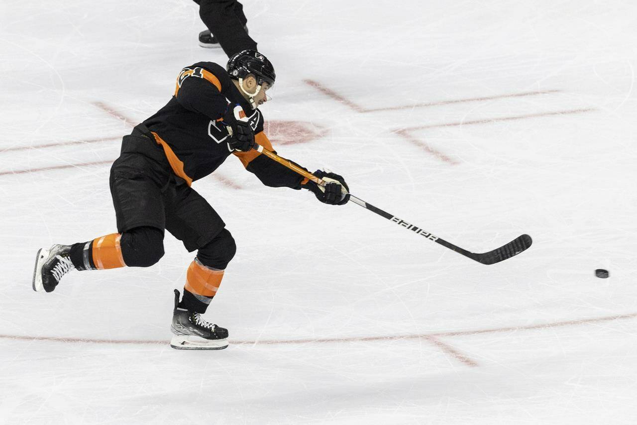 Philadelphia Flyers centre Scott Laughton shoots on goal to score during the second period of an NHL hockey game against the Vancouver Canucks, Saturday, Oct. 15, 2022, in Philadelphia. (AP Photo/Laurence Kesterson)