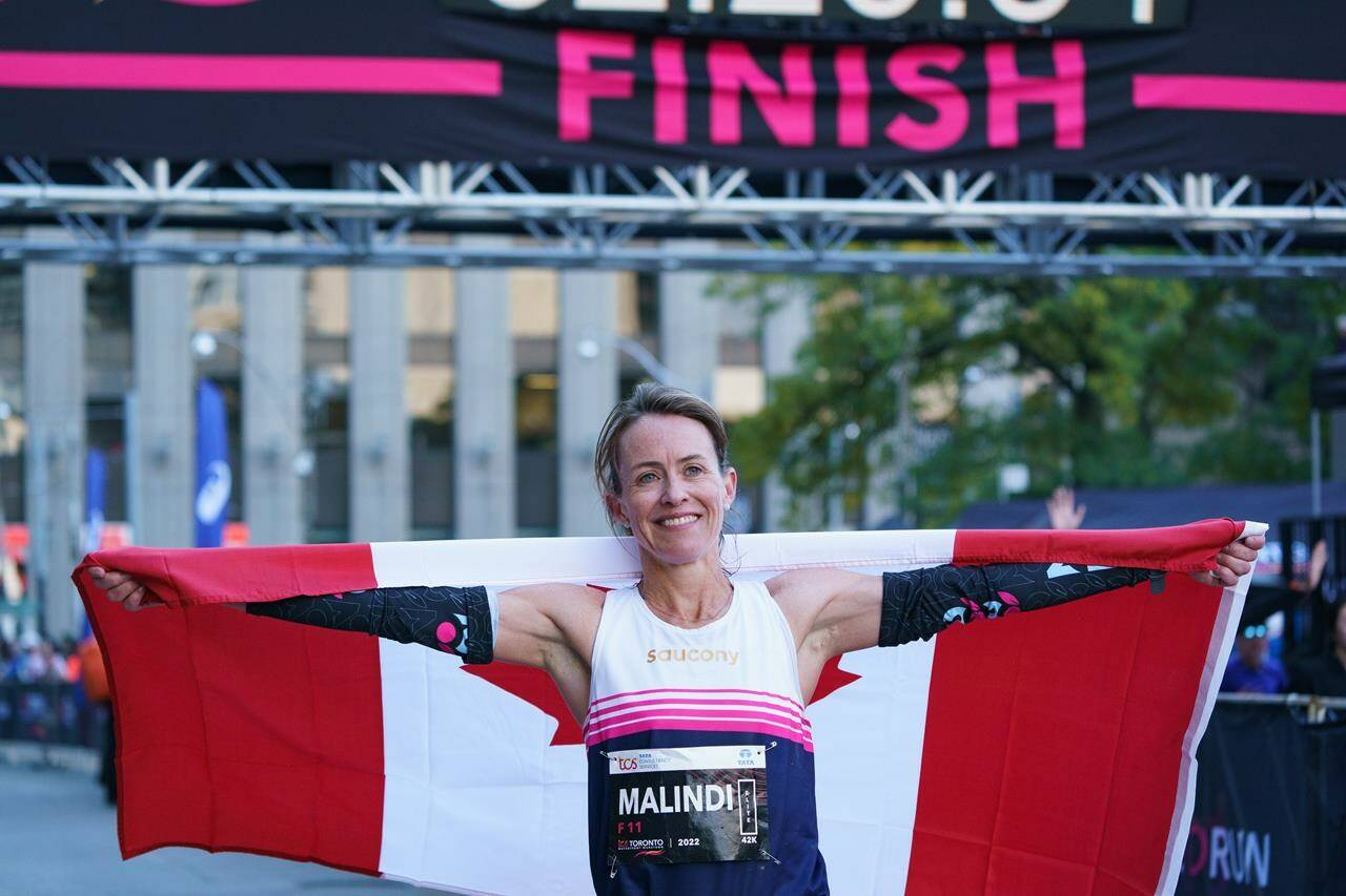 Malindi Elmore celebrates after she finishes the 2022 Toronto Waterfront Marathon as the top Canadian women’s runner in Toronto on Sunday, Oct. 16, 2022. THE CANADIAN PRESS/Alex Lupul
