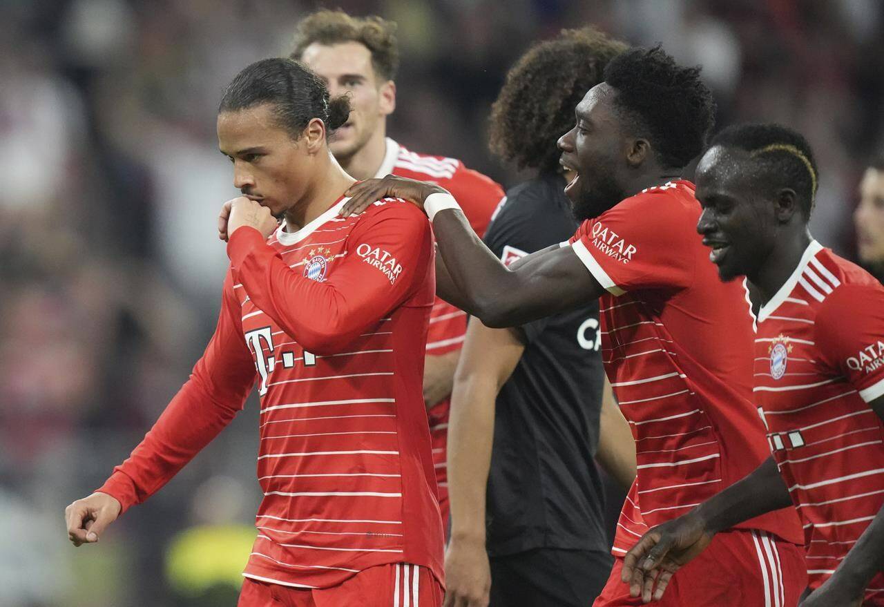 Bayern's Leroy Sane, left, and teammate Alphonso Davies celebrate after scoring his side's third goal during the German Bundesliga soccer match between FC Bayern Munich and SC Freiburg at the Allianz Arena in Munich, Germany, Oct. 16, 2022. THE CANADIAN PRESS/AP-Matthias Schrader