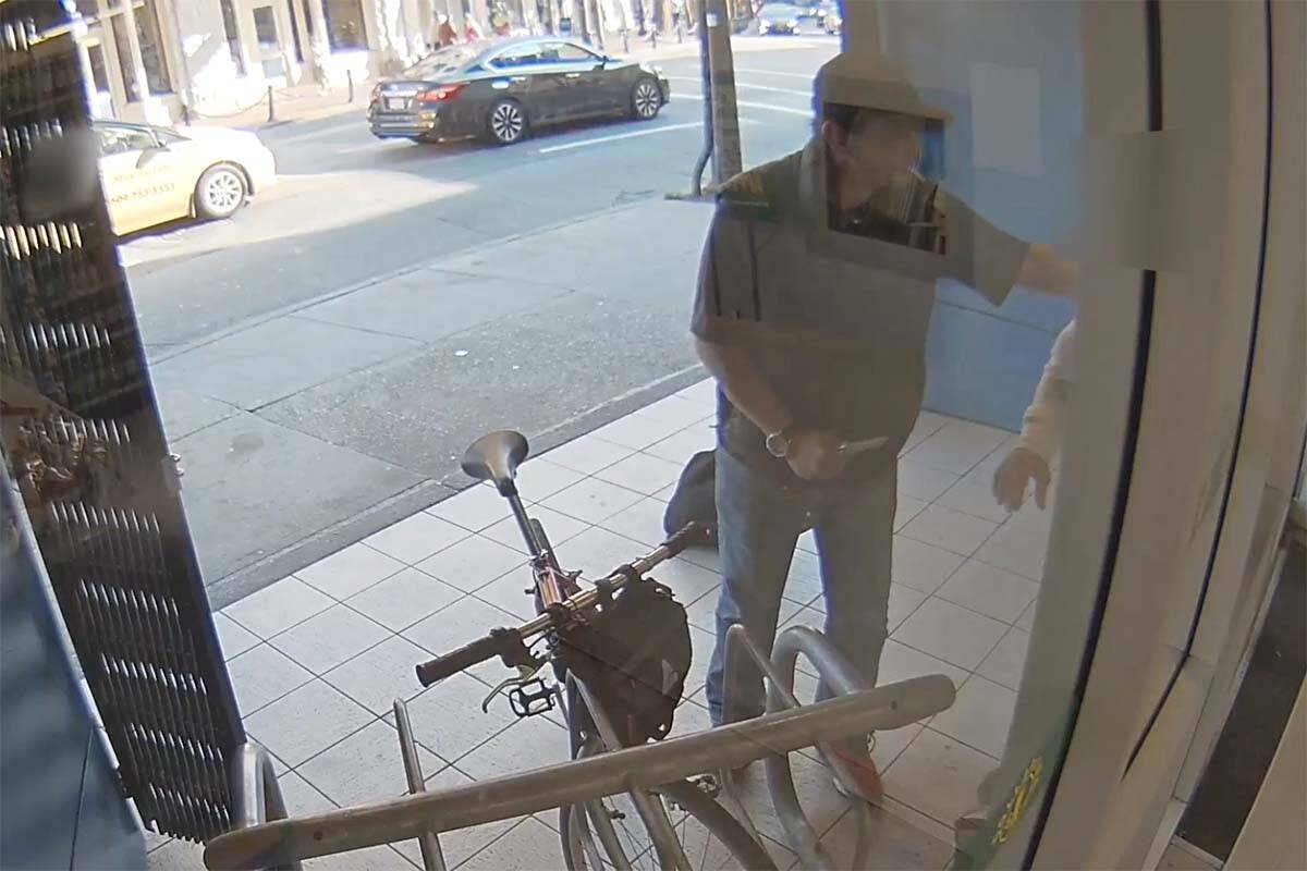 A suspect is seen pulling a knife on someone on West Cordova Street near Richards Street in Vancouver on Oct. 15. Police are asking for help identifying him. (Image courtesy of Vancouver Police Department)