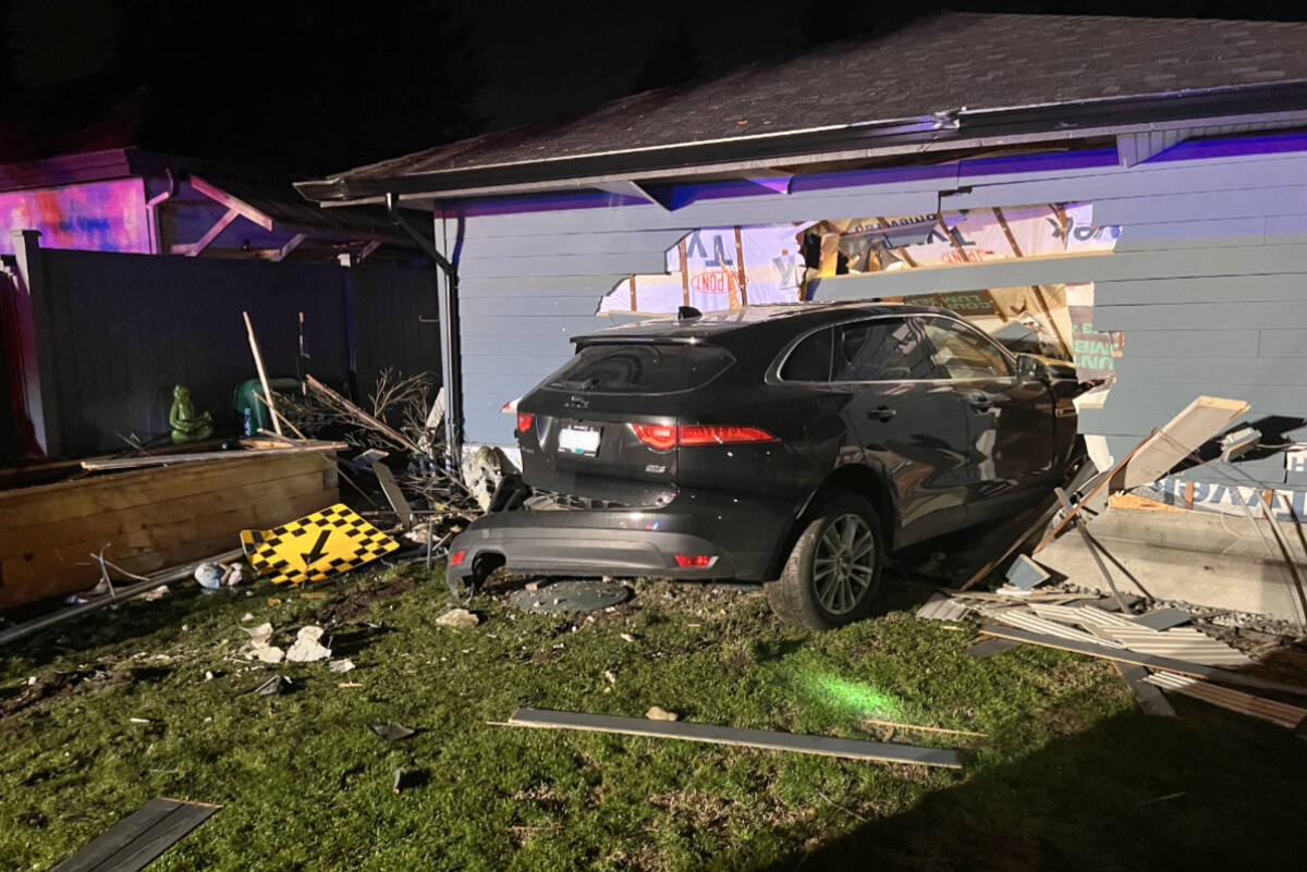 A turn sign, a street identification sign, and several panels of fence were taken out as an SUV careened off the road, through a backyard, and into the side of a Fort Langley home Friday night, Oct. 21, 2022. (Special to Langley Advance Times)