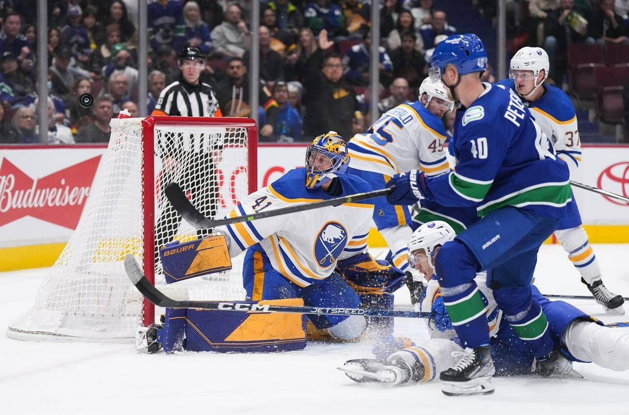 Buffalo Sabres goalie Craig Anderson (41) stops Vancouver Canucks’ Elias Pettersson (40), of Sweden, during the first period of an NHL hockey game in Vancouver, on Saturday, October 22, 2022. THE CANADIAN PRESS/Darryl Dyck