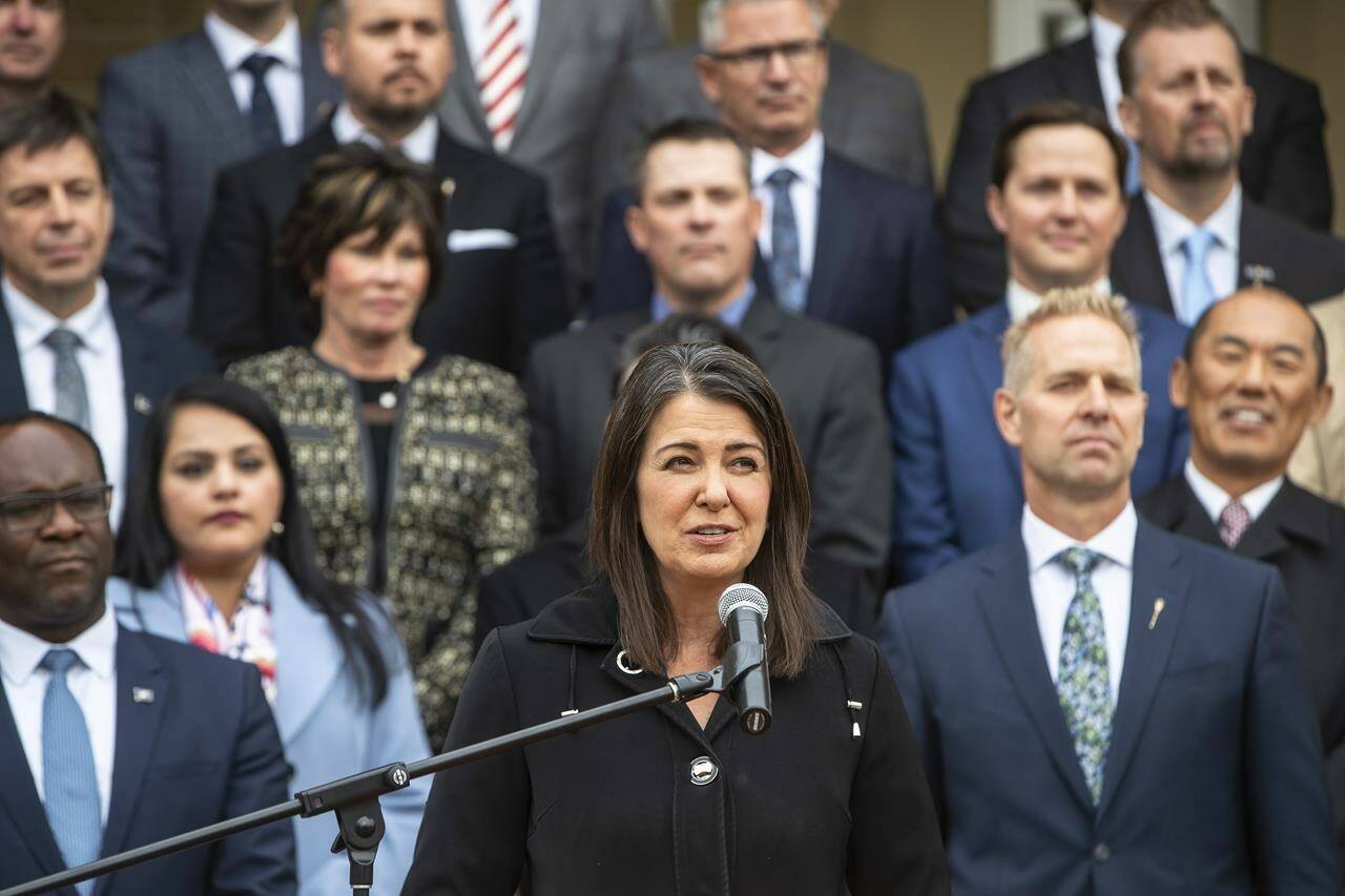 Alberta Premier Danielle Smith, along with cabinet ministers, speaks at a press conference after members were sworn into cabinet in Edmonton, Monday, Oct. 24, 2022. Smith says she is cancelling a health consulting agreement involving the World Economic Forum because she doesn’t want to have any ties with a group that brags about controlling world governments and politicians. THE CANADIAN PRESS/Jason Franson