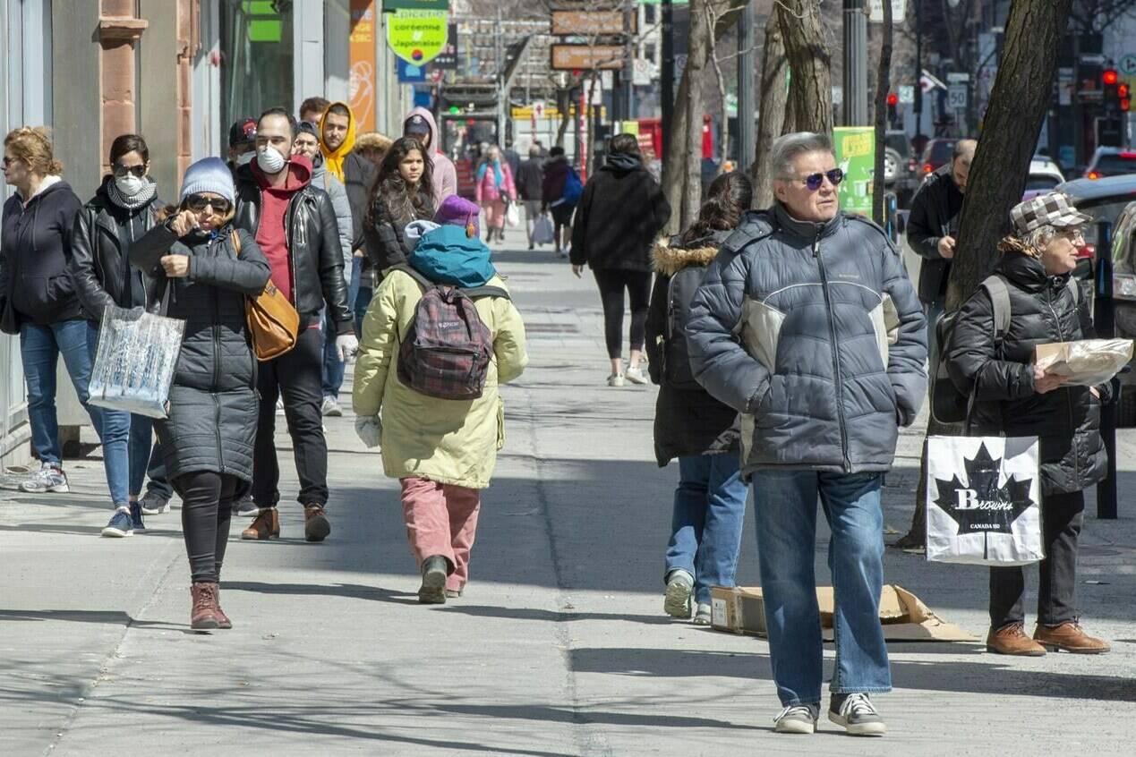 Pedestrians walk down St. Catherine street Monday April 6, 2020 in Montreal.THE CANADIAN PRESS/Ryan Remiorz