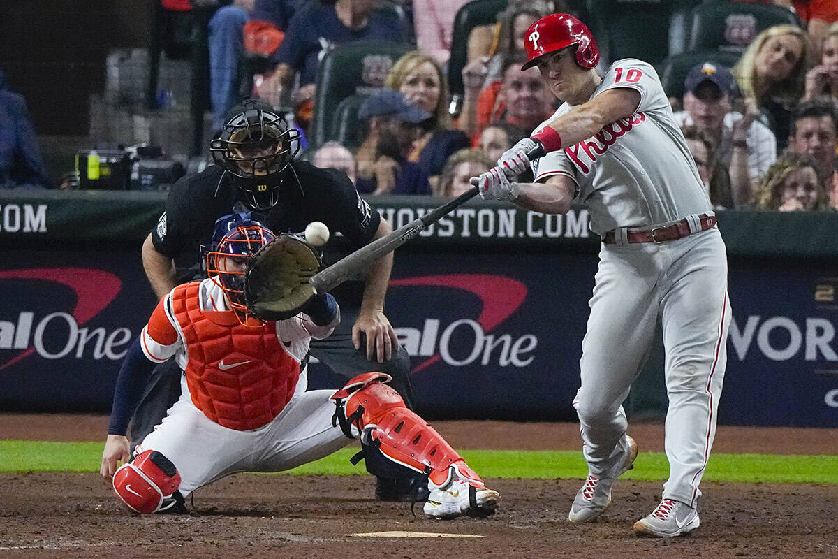 Philadelphia Phillies’ J.T. Realmuto hits a home run during the 10th inning in Game 1 of baseball’s World Series between the Houston Astros and the Philadelphia Phillies on Friday, Oct. 28, 2022, in Houston. (AP Photo/Sue Ogrocki)