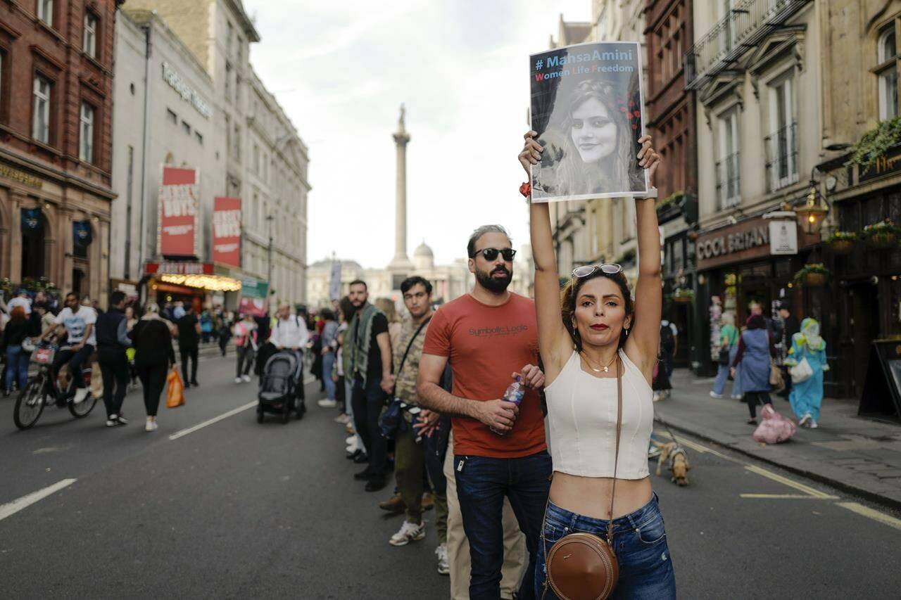 Demonstrators march forming a human chain, as they take part in a protest against Iranian authorities, in London, Saturday, Oct. 29, 2022. THE CANADIAN PRESS/AP-Alberto Pezzali