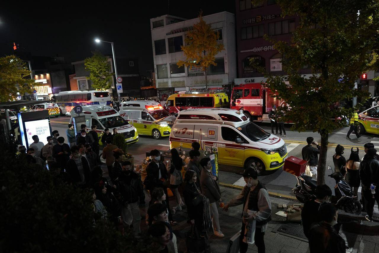 Ambulances carrying victims head to the hospital near the scene in Seoul, South Korea, Sunday, Oct. 30, 2022. Global Affairs says a Canadian was injured in a crowd surge that killed more than 150 people in Seoul, South Korea. THE CANADIAN PRESS/AP-Lee Jin-man