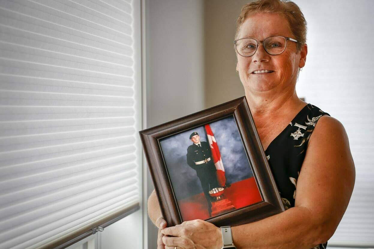 National Silver Cross Mother Candace Greff poses with a picture of her son MCpl. Byron Greff, who was the last soldier to die in Afghanistan, at her home in Lacombe, Alta., Tuesday, Oct. 25, 2022.THE CANADIAN PRESS/Jeff McIntosh