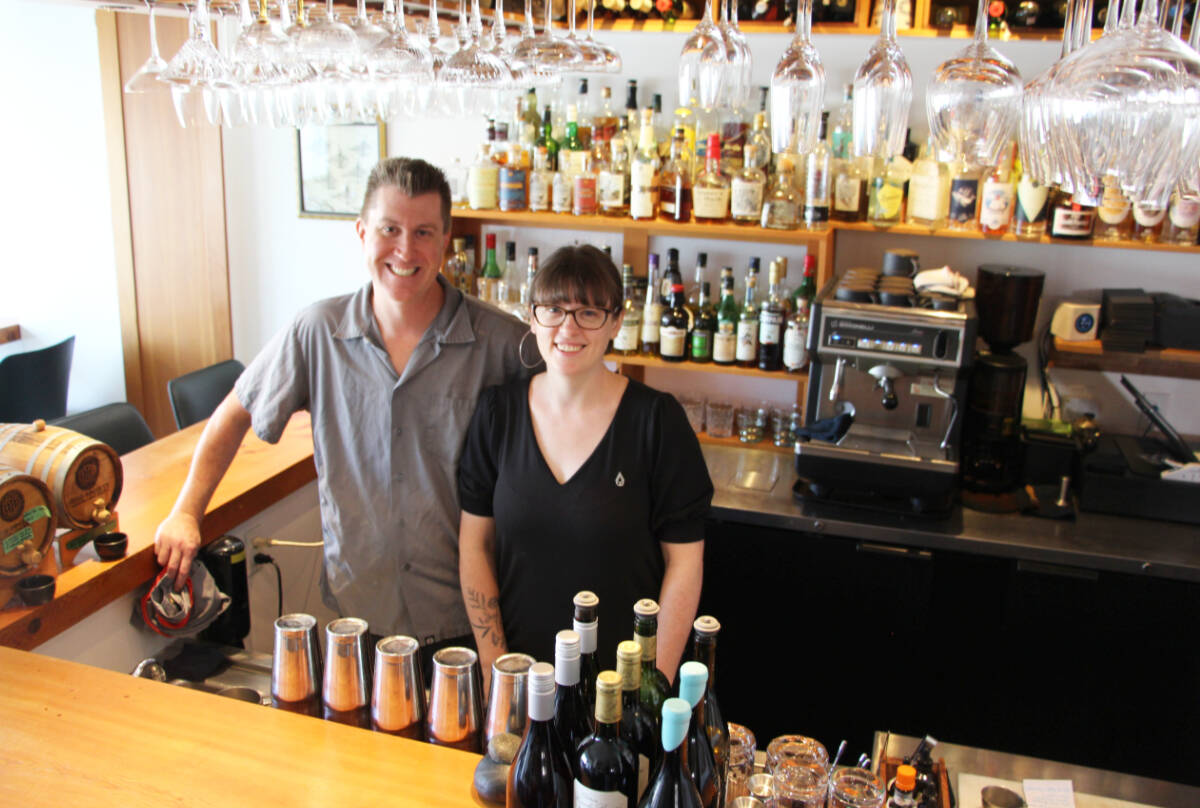 Warren Barr and Lily Verney-Downey smile at the bar of their Pluvio Restaurant, which was recently named Canada’s best fine dining restaurantby TripAdvisor. (Andrew Bailey photo)