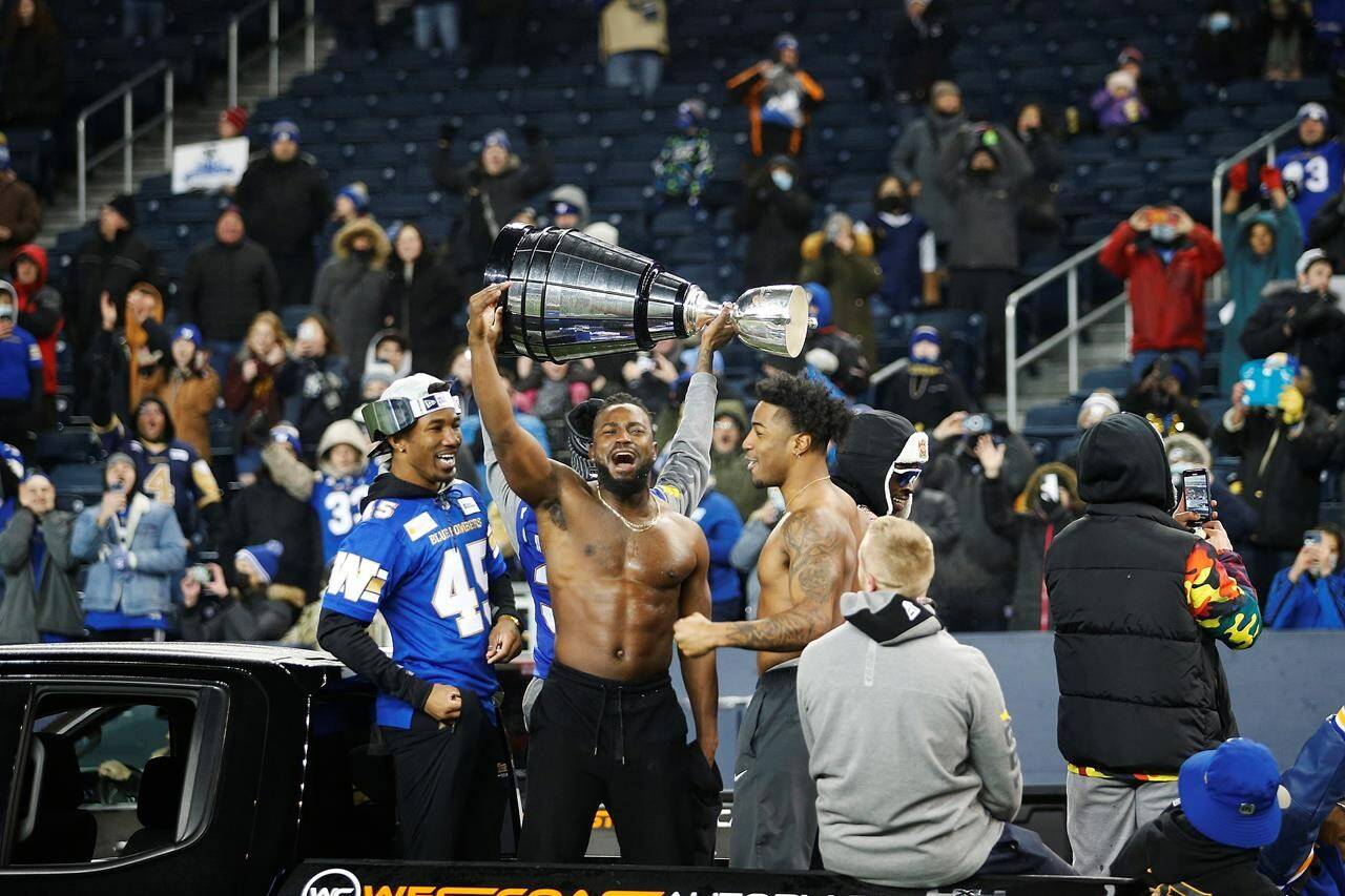 Winnipeg Blue Bombers celebrate their Grey Cup win over the Hamilton Tiger-Cats at a Grey Cup celebration at their stadium in Winnipeg on Wednesday, December 15, 2021. THE CANADIAN PRESS/John Woods