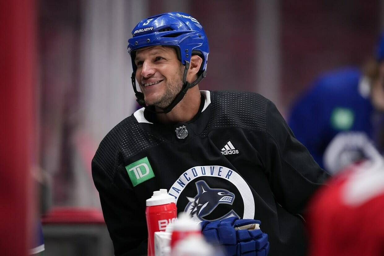 Former Vancouver Canucks defenceman Kevin Bieksa, who signed a one-day contract with the NHL hockey team to officially retire, takes a break as he skates with the team at the start of practice, in Vancouver, B.C., Thursday, Nov. 3, 2022. Bieksa will be honoured by the team with a retirement celebration prior to their game against the Anaheim Ducks on Thursday night. THE CANADIAN PRESS/Darryl Dyck