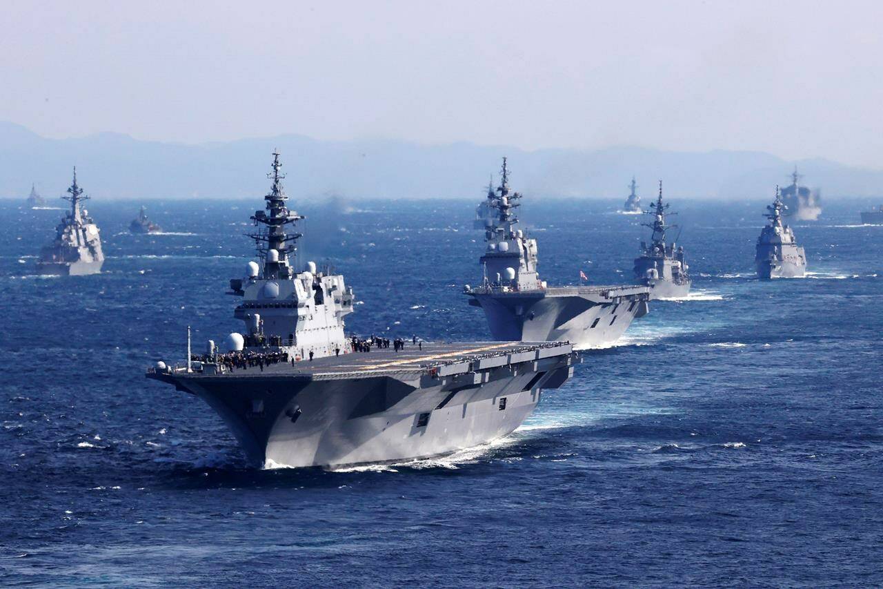 Japan’s Maritime Self-Defense Force helicopter carrier JS Izumo, front, and other warships join an international fleet review in Sagami Bay, south of Tokyo, Sunday, Nov. 6, 2022. Eighteen warships participated from 12 countries, including the United States, Australia, Canada, India, New Zealand, Singapore and South Korea, while the United States and France also sent warplanes for the review. (Kyodo News via AP)