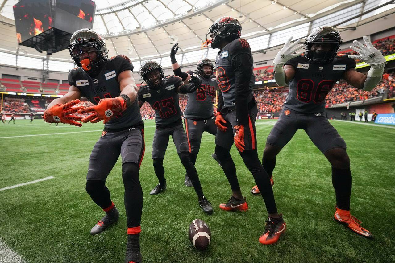 B.C. Lions’ Keon Hatcher, from left to right, Alexander Hollins, Andrew Peirson, Dominique Rhymes and Jevon Cottoy celebrate Hatcher’s touchdown against the Calgary Stampeders during the second half of the CFL western semifinal football game, in Vancouver, B.C., Sunday, Nov. 6, 2022. THE CANADIAN PRESS/Darryl Dyck