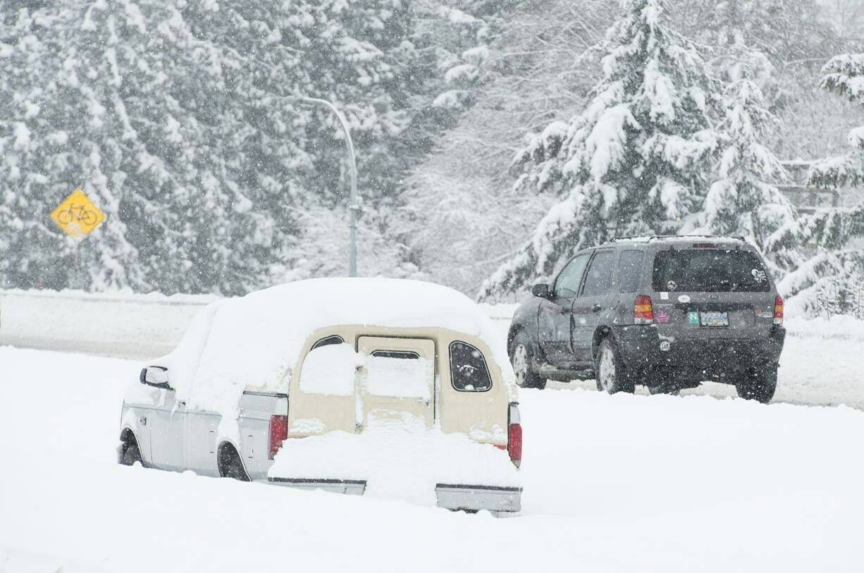 Vehicles make their way along the snow-covered highway in Victoria, B.C., Tuesday, Feb. 12, 2019. THE CANADIAN PRESS/Jonathan Hayward