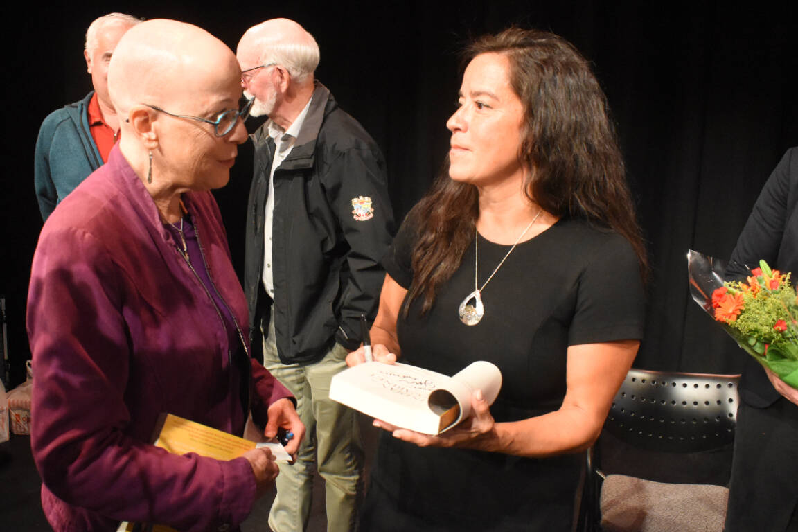 Jody Wilson-Raybould signs a copy of her book for Courtenay-Comox MLA Ronna-Rae Leonard during Wilson-Raybould’s induction ceremony into the Comox Valley Walk of Achievement. Photo by Terry Farrell