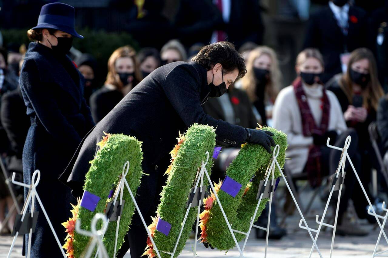 Prime Minister Justin Trudeau is accompanied by his wife Sophie Gregoire Trudeau as he places a wreath at the National War Memorial during the National Remembrance Day Ceremony in Ottawa, on Thursday, Nov. 11, 2021. THE CANADIAN PRESS/Justin Tang