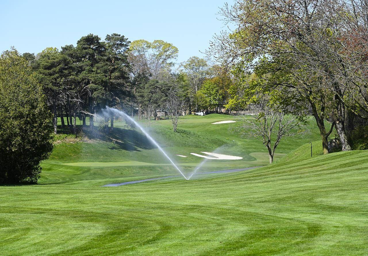 Sprinklers water the fairways at Lakeview Golf Course in Mississauga, Ont., on Wednesday, May 12, 2021. Golf’s origins date back hundreds of years to rural Scotland where the natural features of the land near Edinburgh created the hazards that golfers had to play around and sheep kept the grass well manicured. THE CANADIAN PRESS/Nathan Denette