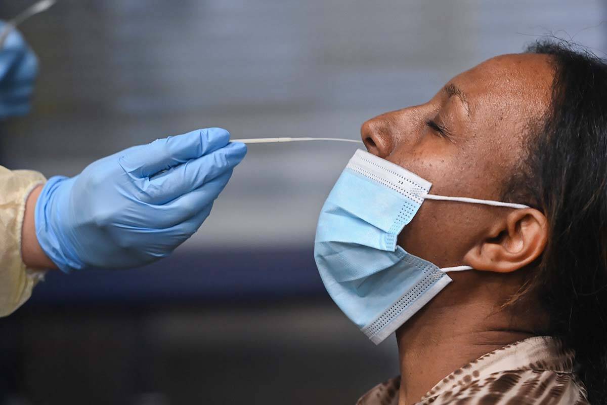 A health-care worker tests a woman at a pop-up COVID-19 assessment centre in Toronto on May 19, 2021. University of British Columbia researchers are looking for Canadians with long COVID to take part in a research project. THE CANADIAN PRESS/Nathan Denette