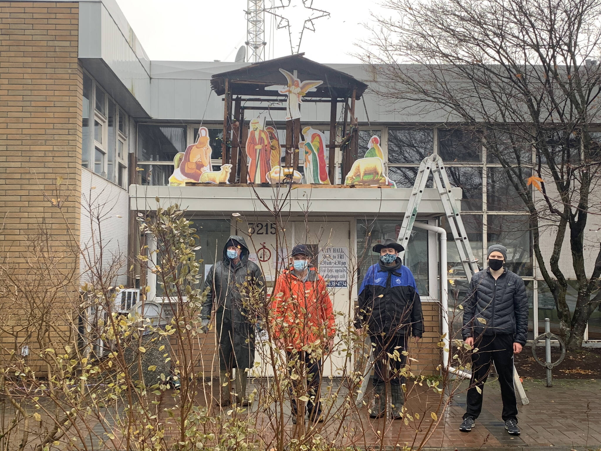 Knights of Columbus volunteers in 2021 pose for a photo of the nativity scene they had just put up at city hall. The city is banning the practice this year. (Contributed photo)