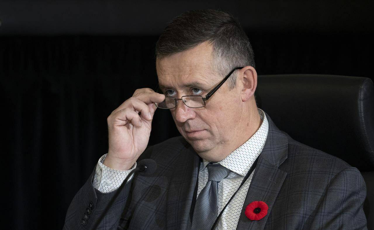 Alberta civil servant Marlin Degrand removes his glasses as he listens to a lawyer’s question during his testimony at the Public Order Emergency Commission, Thursday, Nov. 10, 2022 in Ottawa. THE CANADIAN PRESS/Adrian Wyld