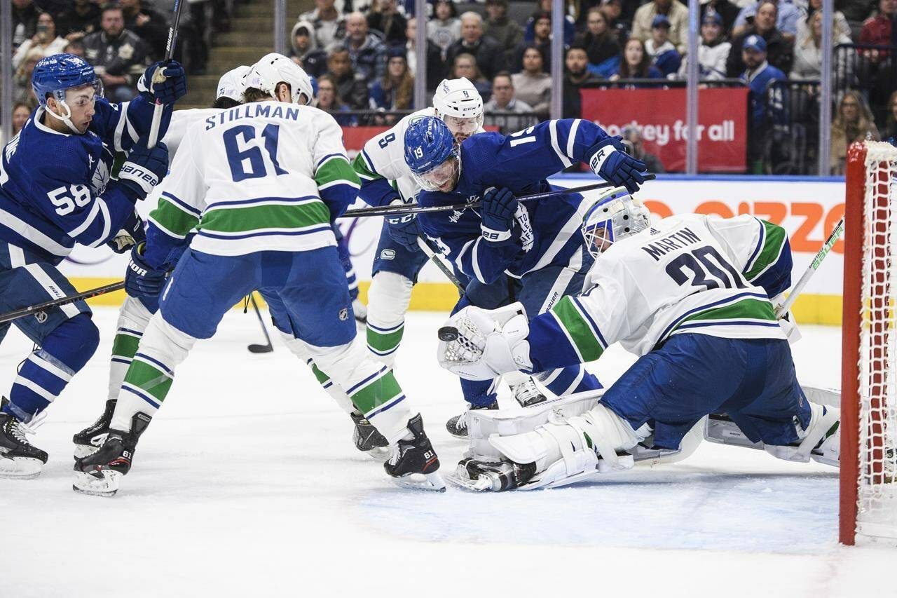 Vancouver Canucks goaltender Spencer Martin (30) defends against an attack on net by centre Calle Jarnkrok (19) and left wing Michael Bunting (58) during second period NHL hockey action, in Toronto on Saturday, Nov. 12, 2022. THE CANADIAN PRESS/Christopher Katsarov