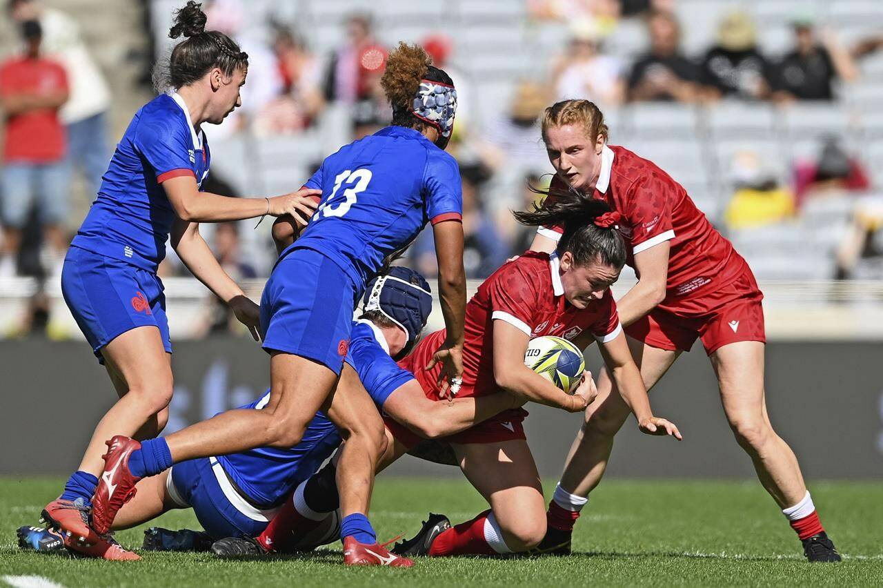 Canada’s Alysha Corrigan, second right, is supported by teammate Maddy Grant as France’s Maelle Filopon, second left, comes in to help in the tackle in the bronze medal game of the women’s rugby World Cup at Eden Park in Auckland, New Zealand, Saturday, Nov.12, 2022. The Canadian women return home from the Rugby World Cup proud but disappointed after a tournament that saw them impress prior to running into a classy French side in the bronze-medal match.THE CANADIAN PRESS/AP, Photosport, Andrew Cornaga