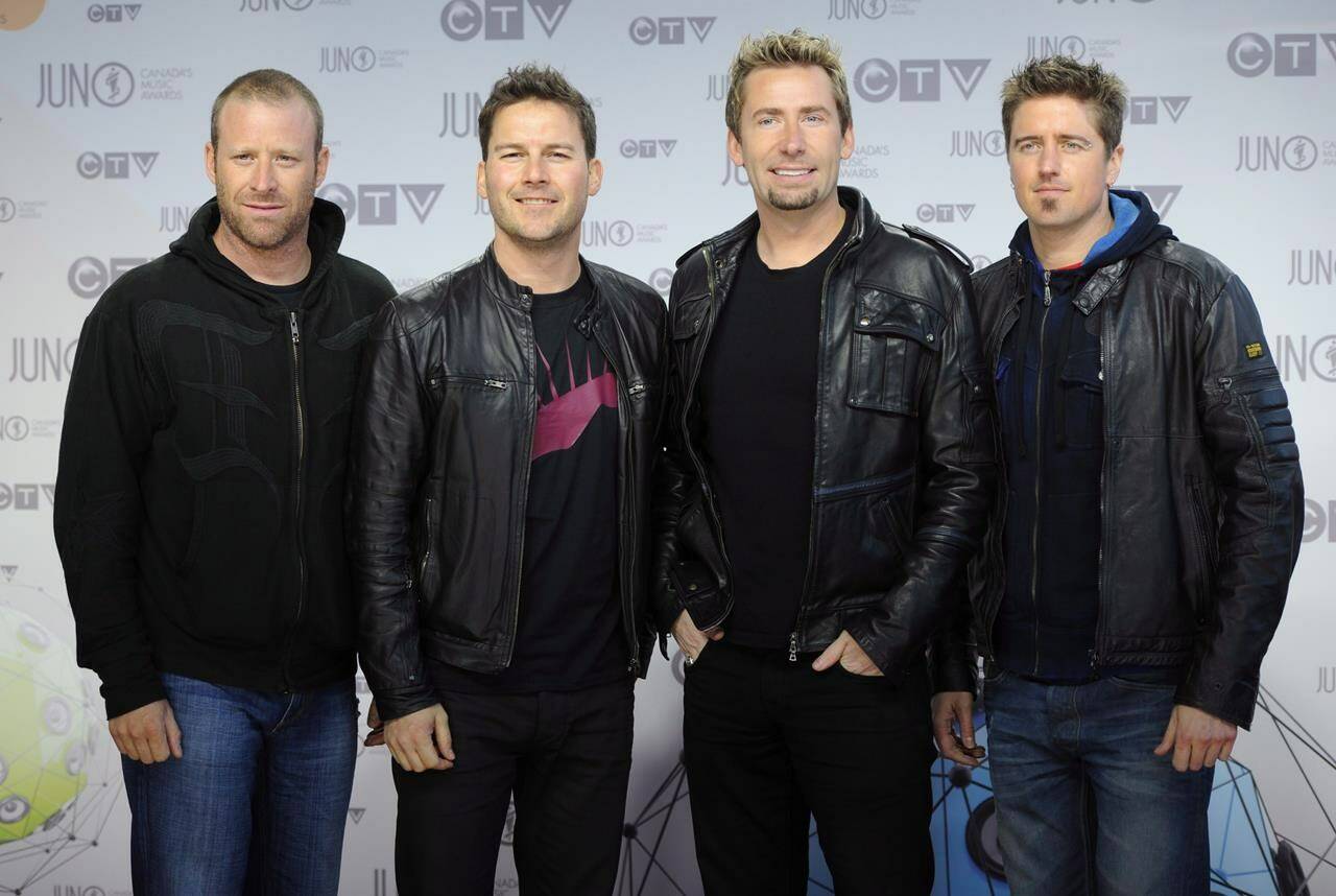 Members of Nickelback pose for photographers as they arrive on the red carpet at the Juno Awards in Ottawa, Sunday April 1, 2012. THE CANADIAN PRESS/Sean Kilpatrick