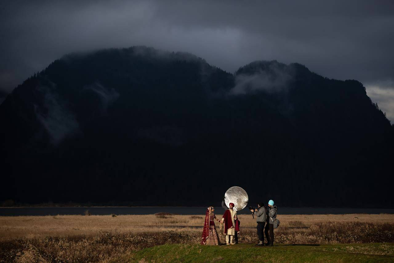 Newlyweds Deep Punia, left, and Parminder Punia pose for wedding photos at Pitt-Addington Marsh nature preserve, in Pitt Meadows, B.C., Saturday, Feb. 6, 2021. Statistics Canada says 98,355 marriages were registered in Canada in 2020 -- one-third lower than in 2019 -- likely due to COVID-19 and the various public health measures that were introduced mid-March. THE CANADIAN PRESS/Darryl Dyck