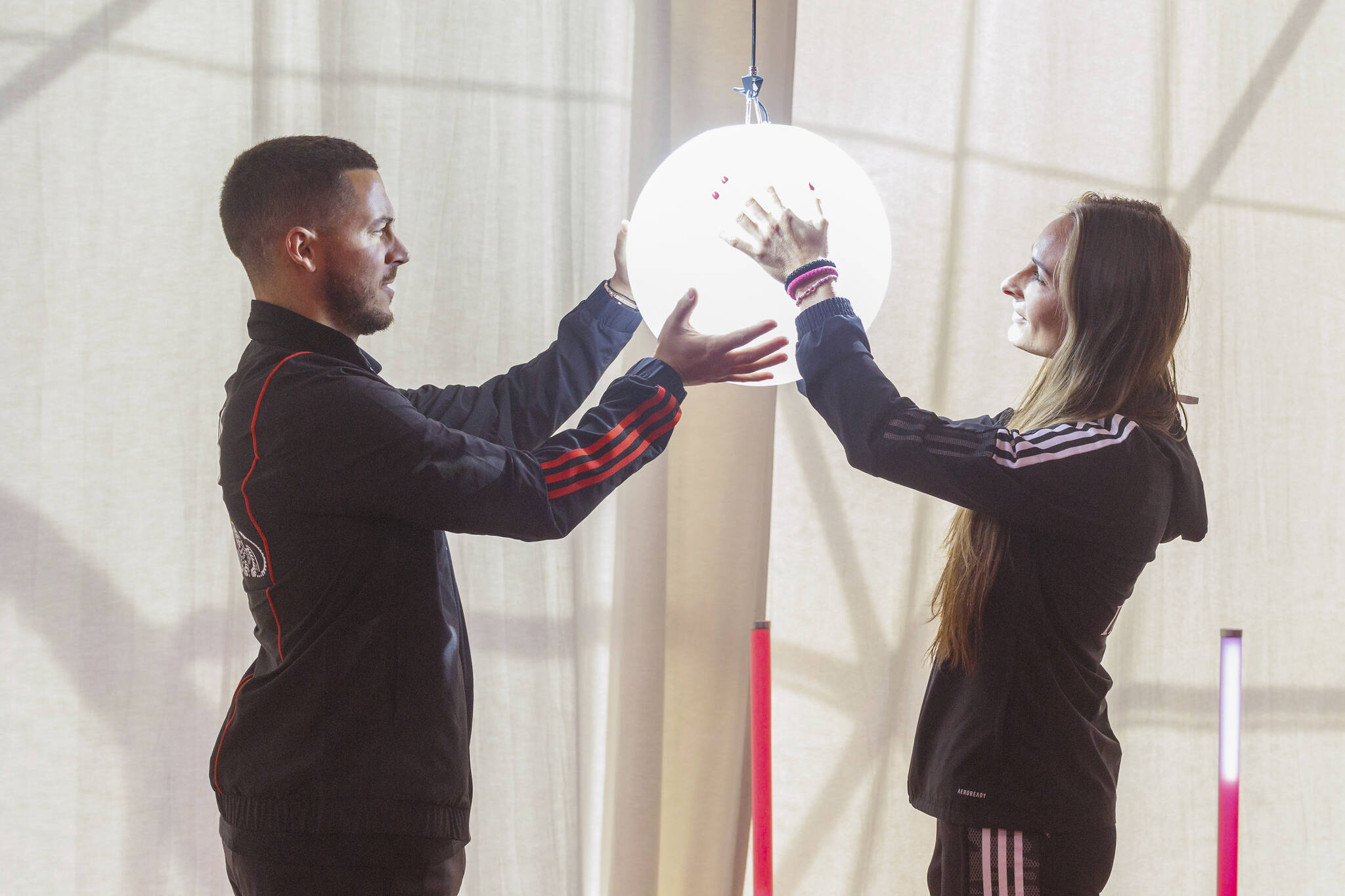 Eden Hazard, left, and Tessa Wullaert, captains of the Belgian men’s and women’s national soccer teams, hold a globe during a farewell ceremony for the Red Devils, the men’s soccer team, at the airport in Brussels, Belgium, Tuesday, Nov. 15, 2022. The Belgian team leaves for Kuwait where it will play a friendly match on Friday against Egypt and then fly onto Qatar to participate in the World Cup. (AP Photo/Olivier Matthys)