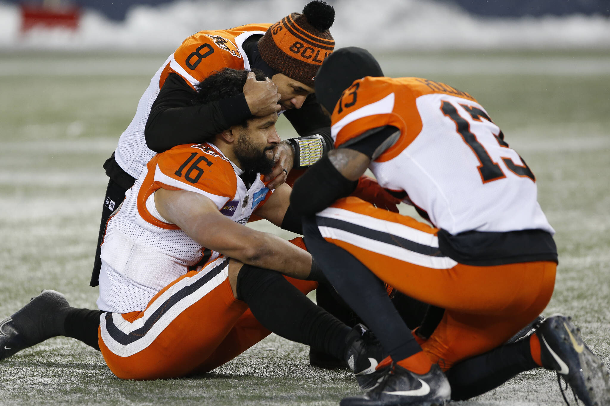 BC Lions’ quarterback Vernon Adams (8), Bryan Burnham (16) and Alexander Hollins (13) comfort eachother after losing to the Winnipeg Blue Bombers in the CFL western final in Winnipeg, Sunday, Nov. 13, 2022. THE CANADIAN PRESS/John Woods