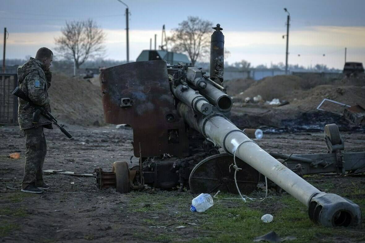 A Ukrainian soldier inspects a damaged Russian cannon in the recently retaken village Chornobaivka near Kherson, Ukraine, Tuesday, Nov. 15, 2022. THE CANADIAN PRESS/AP, Efrem Lukatsky