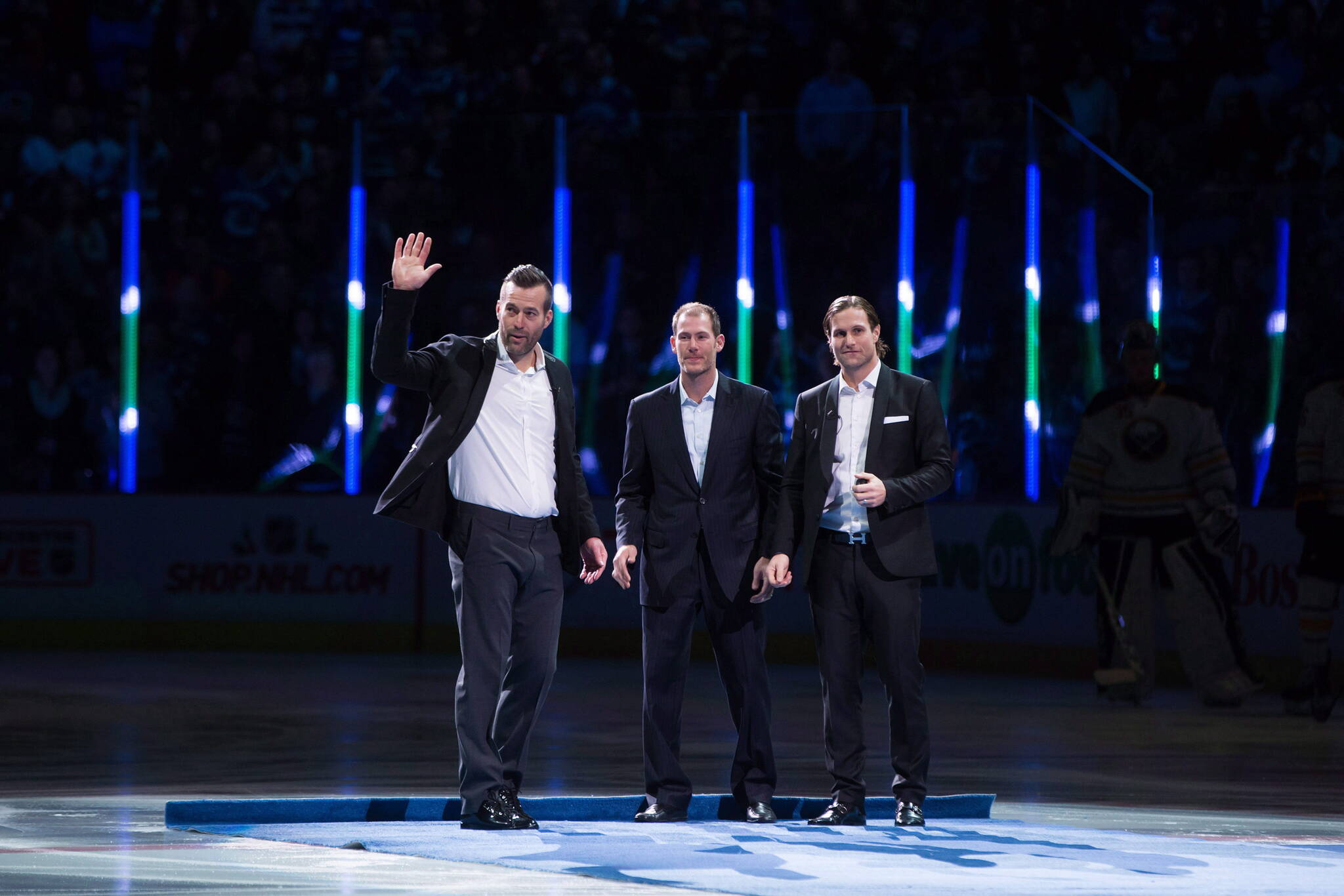 Former Vancouver Canucks linemates Todd Bertuzzi, from left, Brendan Morrison and Markus Naslund, of Sweden, are honoured during a ceremony before the Vancouver Canucks and Buffalo Sabres play an NHL hockey game in Vancouver, B.C., on Monday December 7, 2015. THE CANADIAN PRESS/Darryl Dyck