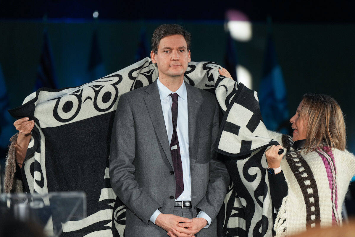 B.C. Premier David Eby is wrapped in a ceremonial blanket by First Nations people during a swearing in ceremony where he became the province’s 37th premier at the Musqueam Nation, in Vancouver, B.C., Friday, Nov. 18, 2022. THE CANADIAN PRESS/Darryl Dyck