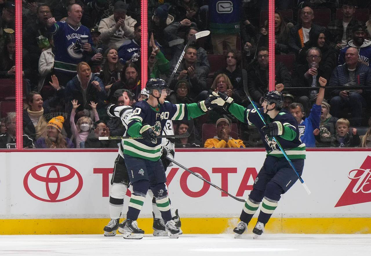 Vancouver Canucks’ Elias Pettersson, left, of Sweden, and Ilya Mikheyev, of Russia, celebrate Pettersson’s goal against the Los Angeles Kings during the second period of an NHL hockey game in Vancouver, on Friday, Nov. 18, 2022. THE CANADIAN PRESS/Darryl Dyck