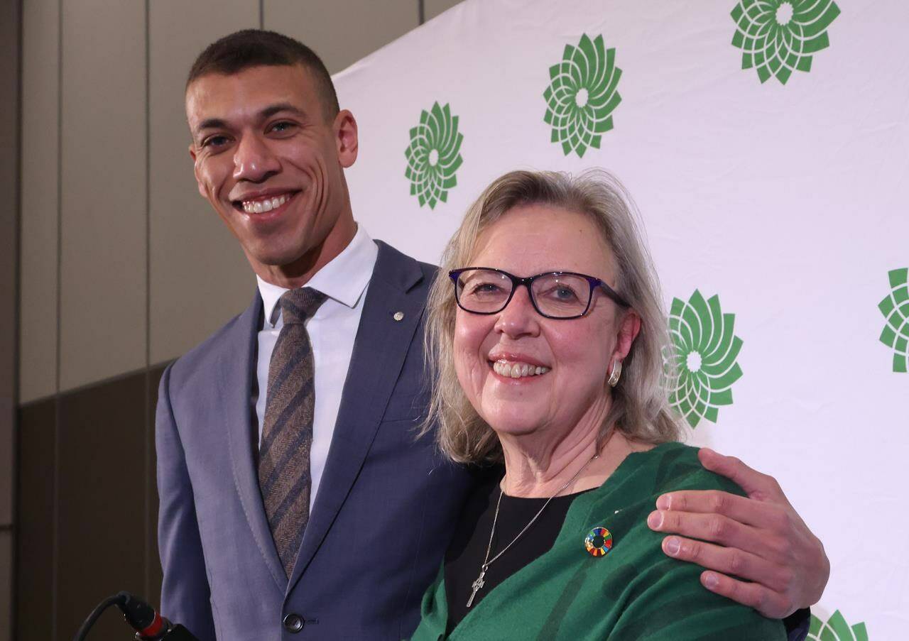 Co-leadership candidates Jonathan Pedneault and Elizabeth May pose for a photo before the new leader of the Green Party is chosen in Ottawa on Saturday, November 19, 2022. THE CANADIAN PRESS/ Patrick Doyle
