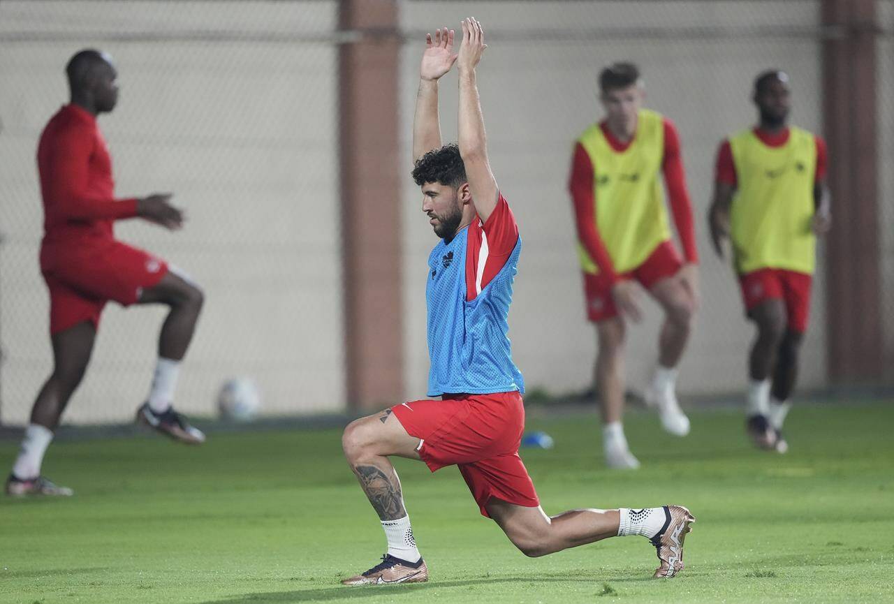Canada midfielder Jonathan Osorio stretches during practice at the World Cup in Doha, Qatar during on Sunday, November 20, 2022. THE CANADIAN PRESS/Nathan Denette