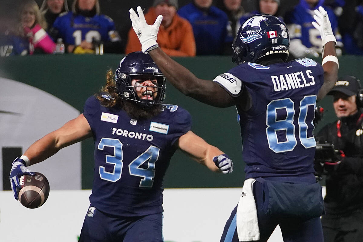 Toronto Argonauts running back AJ Ouellette (34) celebrates his touchdown with wide receiver DaVaris Daniels (80) during second half football action against the Winnipeg Blue Bombers in the 109th Grey Cup at Mosaic Stadium in Regina, Sunday, Nov. 20, 2022. THE CANADIAN PRESS/Heywood Yu