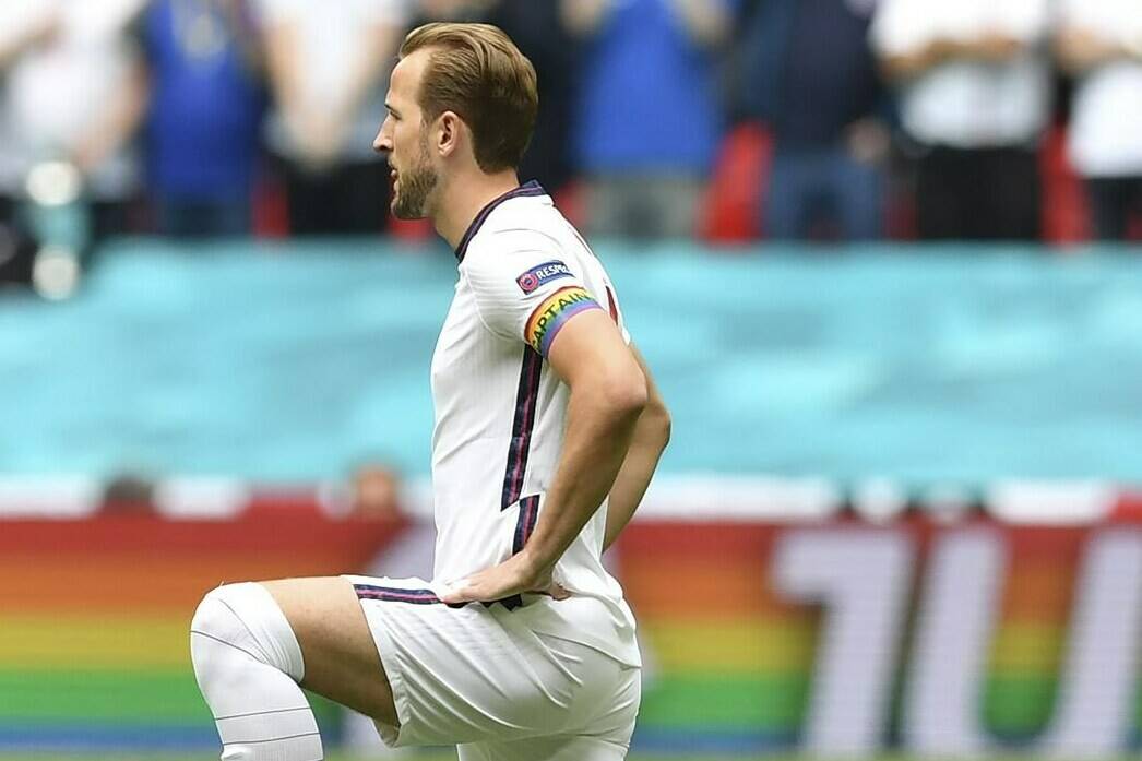 FILE - England’s Harry Kane wears a rainbow armband as he takes the knee prior to the Euro 2020 soccer championship round of 16 match between England and Germany at Wembley Stadium in England. The captains of seven European nations will not wear anti-discrimination armbands in World Cup games after threats from FIFA to show yellow cards to the players. The seven soccer federations say “we can’t put our players in a position where they could face sporting sanctions.” (Justin Tallis, Pool Photo via AP)
