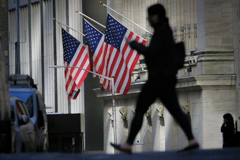 FILE - A pedestrian walks past the New York Stock Exchange in New York City, Thursday, Oct. 27, 2022. (AP Photo/J. David Ake, File)