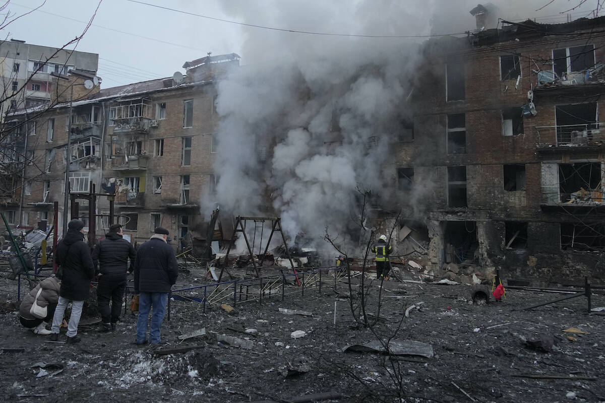 People check a damaged building as emergency personnel work at the scene of a Russian shelling in the town of Vyshgorod outside the capital Kyiv, Ukraine, Wednesday, Nov. 23, 2022. (AP Photo/Efrem Lukatsky)