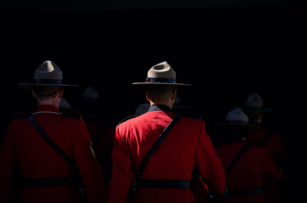 FILE – RCMP officers in Red Serge parade into a change of command ceremony for incoming B.C. RCMP Commanding Officer, Deputy Commissioner Dwayne McDonald, in Langley, B.C., on Tuesday, September 20, 2022. THE CANADIAN PRESS/Darryl Dyck