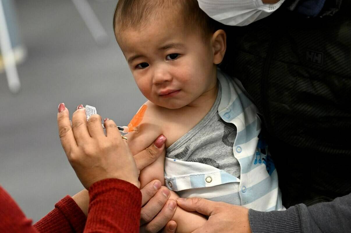 Taika Loo, 16 months, receives a COVID-19 vaccine at a clinic in Ottawa, on Wednesday, Nov. 23, 2022. Preventable diseases like measles could spread quickly in Canada like elsewhere in the world due to a drop in routine vaccinations during the pandemic, say pediatricians who are urging parents to ensure their kids are fully immunized.THE CANADIAN PRESS/Justin Tang