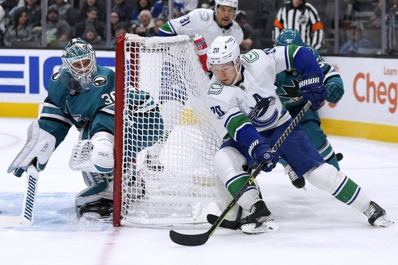 Vancouver Canucks centre Curtis Lazar looks to score against San Jose Sharks goaltender Kaapo Kahkonen during the first period of an NHL hockey game, Sunday, Nov. 27, 2022, in San Jose, Calif. (AP Photo/Tony Avelar)