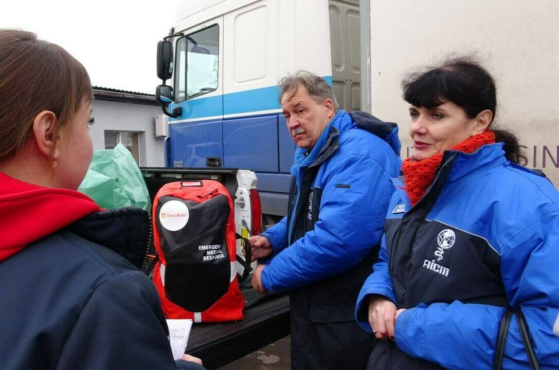 Dr. Christian Carrer and his partner Tetyana Grebenchykova, heads of the organization AICM, give a special emergency kit bag for first respondents to Paulina, an emergency room manager in the region of Balakliya, recently liberated by the Ukrainian army, on Friday Nov. 25, 2022. THE CANADIAN PRESS/Patrice Bergeron