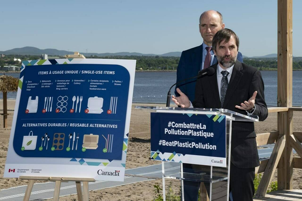 Federal Minister of Environment and Climate Change Steven Guilbeault, announces the ban of single-use plastics, at a beach, on Monday, June 20, 2022 in Quebec City. Federal Health Minister Jean-Yves Duclos, behind, looks on. THE CANADIAN PRESS/Jacques Boissinot