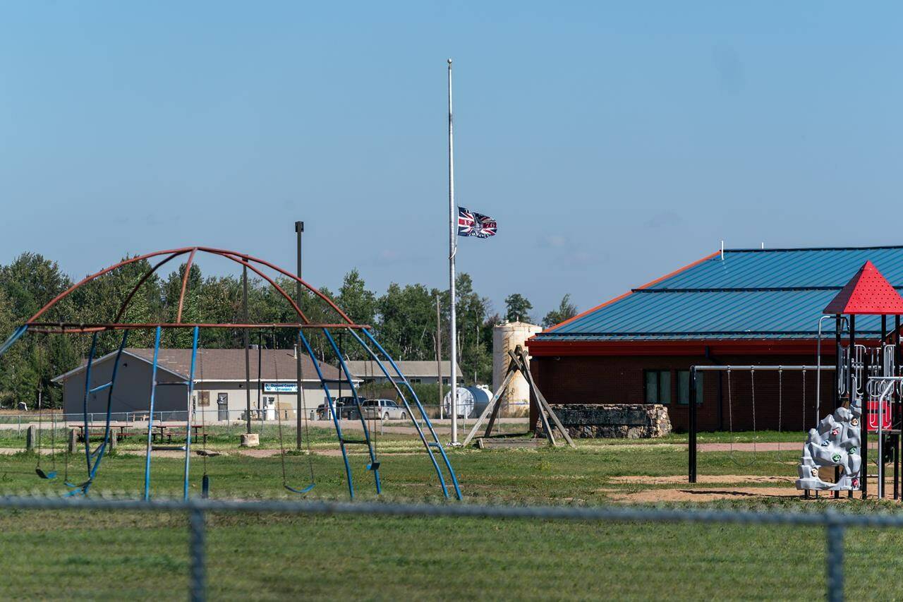 A flag flies at half mast in James Smith Cree Nation, Sask., Tuesday, Sept. 6, 2022. Prime Minister Justin Trudeau will visit a First Nation in Saskatchewan that was rocked by a deadly stabbing rampage nearly three months ago. THE CANADIAN PRESS/Heywood Yu