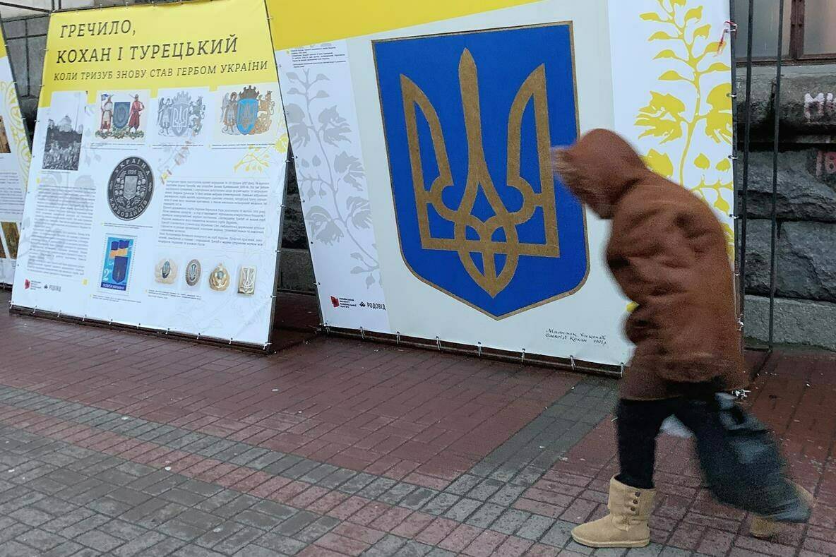 A person walks past signage in downtown Kyiv, Ukraine on Thursday Nov. 29, 2022. Residents of Kyiv waited with patience and resignation Tuesday as all signs pointed toward another imminent Russian bombing of their city. THE CANADIAN PRESS/Patrice Bergeron