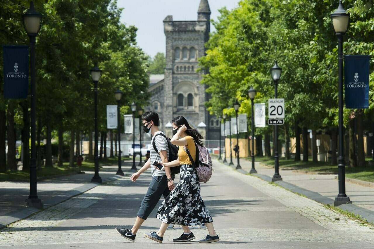 People walk past the University of Toronto campus in Toronto on Wednesday, June 10, 2020. THE CANADIAN PRESS/Nathan Denette